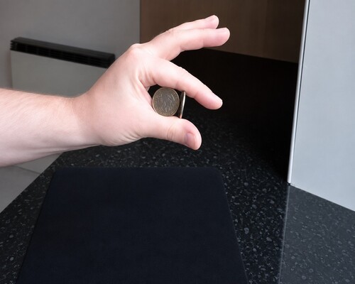 The small coin positioned vertically in front of the two larger coins